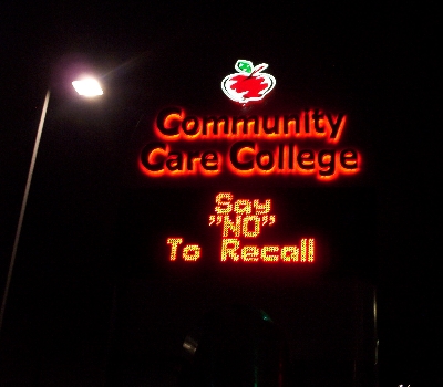 Community Care College sign reads: Say NO To Recall