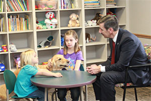 Tulsa County Assistant District Attorney Steve Kunzweiler with a therapy dog