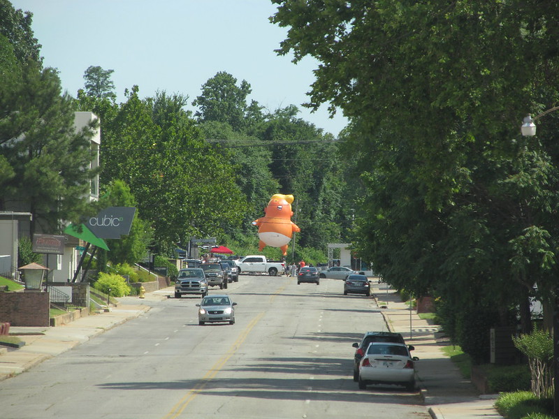 Looking south on Boston Ave, Trump Baby Balloon floats above 18th and Boston