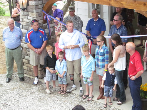 Spec. B. J. Jackson, surrounded by his wife and children, speaks at the dedication of the Folds of Honor cottage on Skiatook Lake